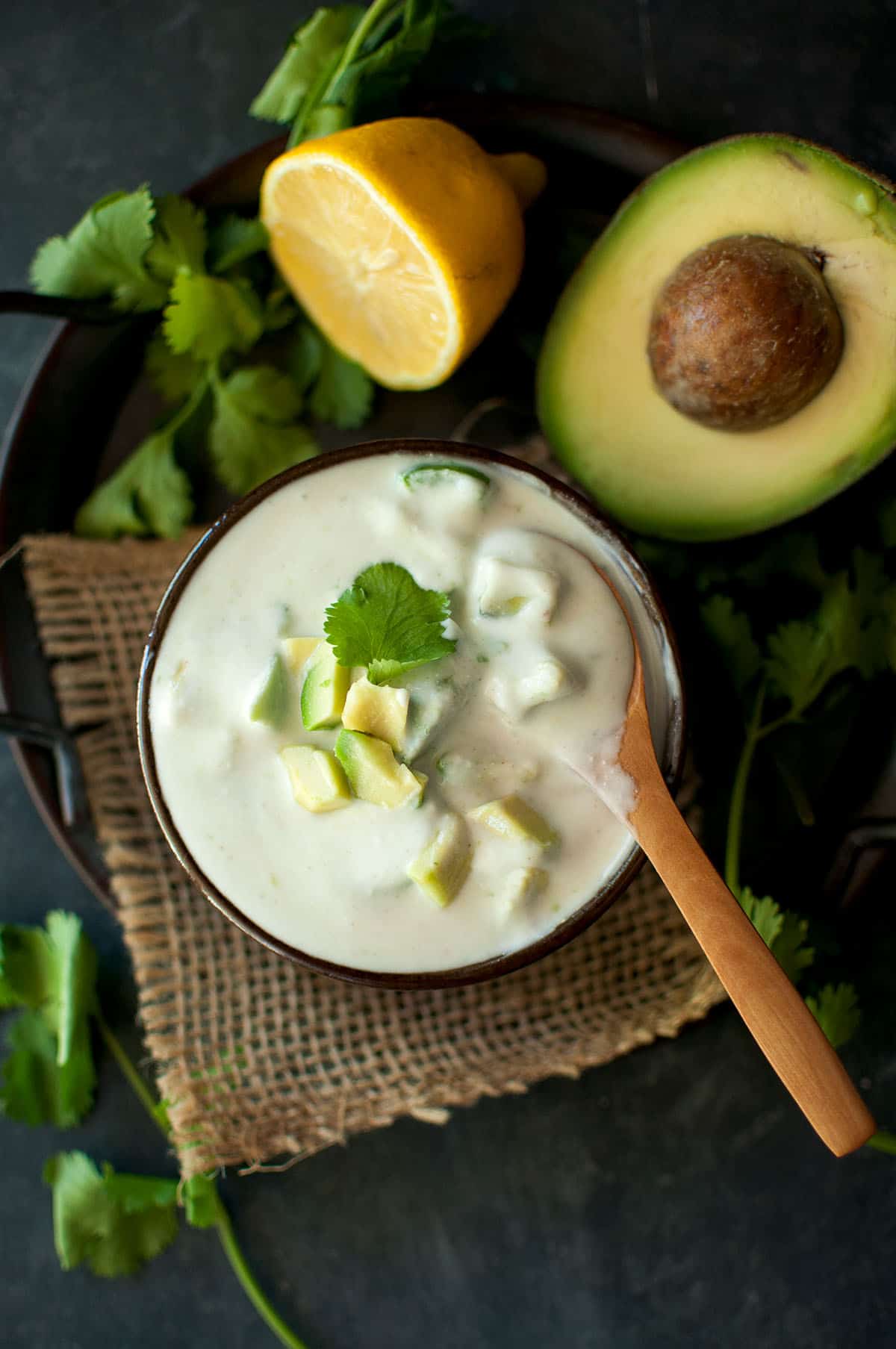 Top view of a brown bowl with avocado raita.