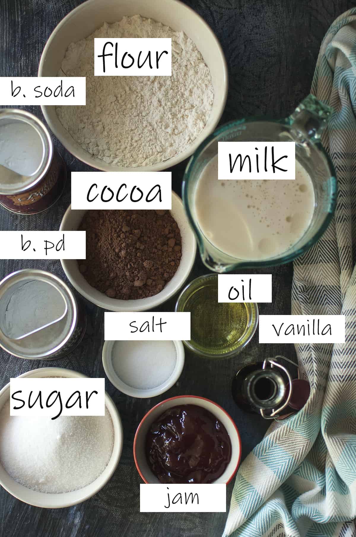 Ingredients needed to make the cake recipe placed in bowls