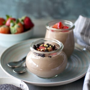 Blue plate with cups of chocolate custard.