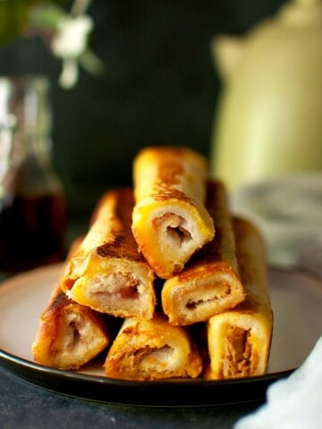 Plate with a stack of French toast rolls