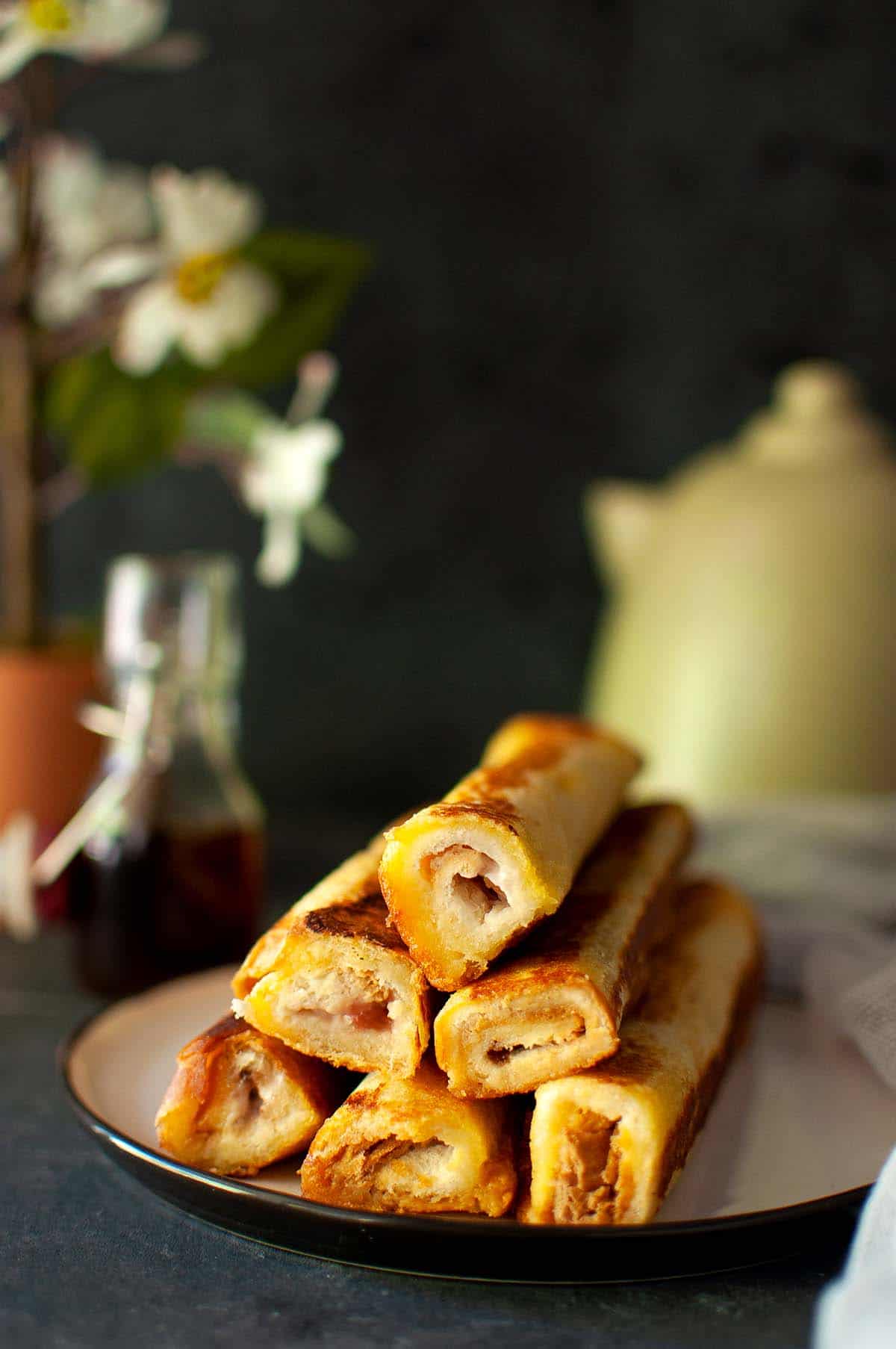 Black plate with a stack of French Toast roll ups