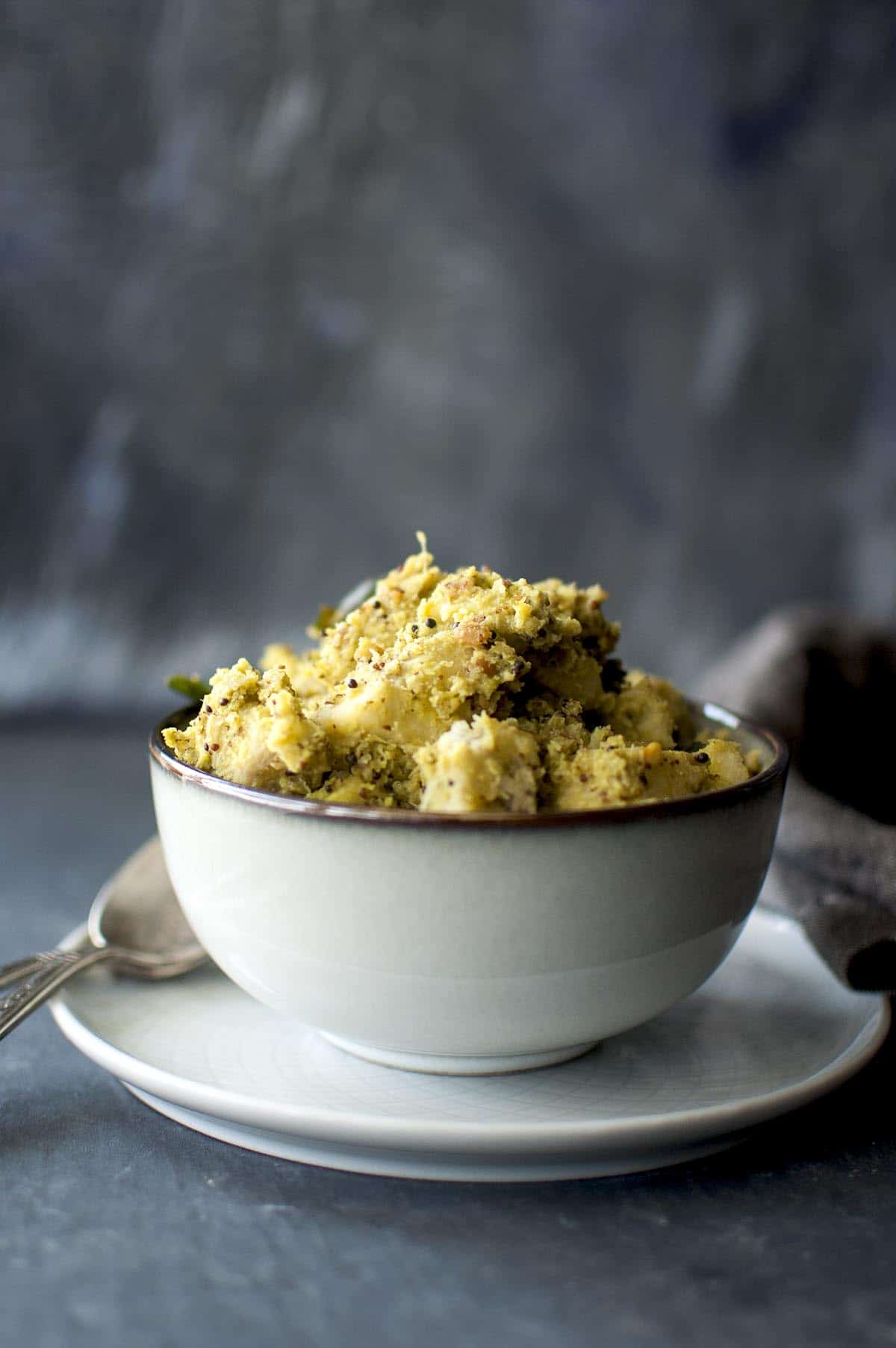 grey bowl with aratikaya kura on a grey plate