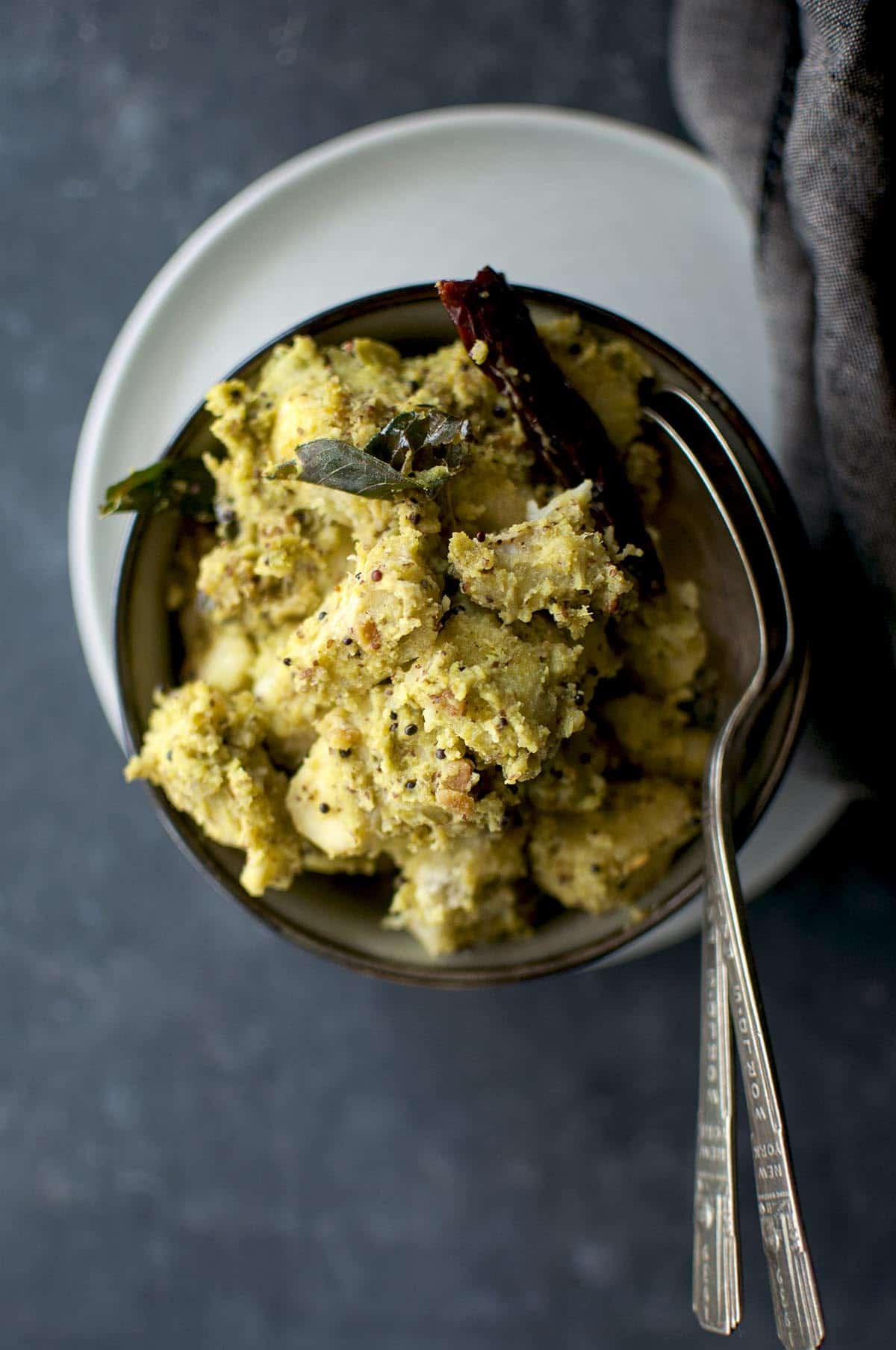 Top view of grey bowl with raw banana curry