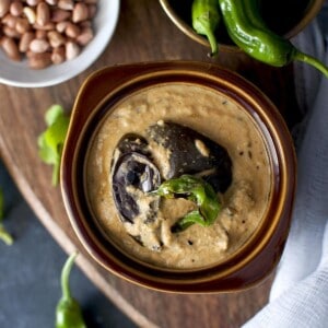 Top view of brown bowl with baingan mirchi ka saalan