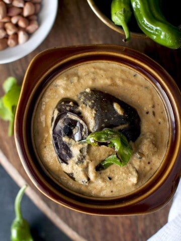 Top view of brown bowl with baingan mirchi ka saalan