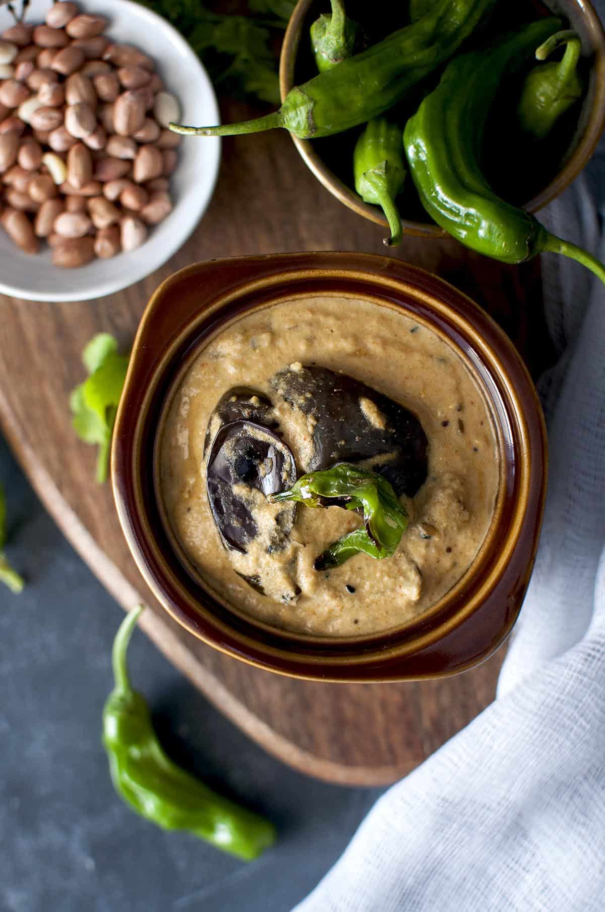 Brown bowl with brinjal salan with chilis