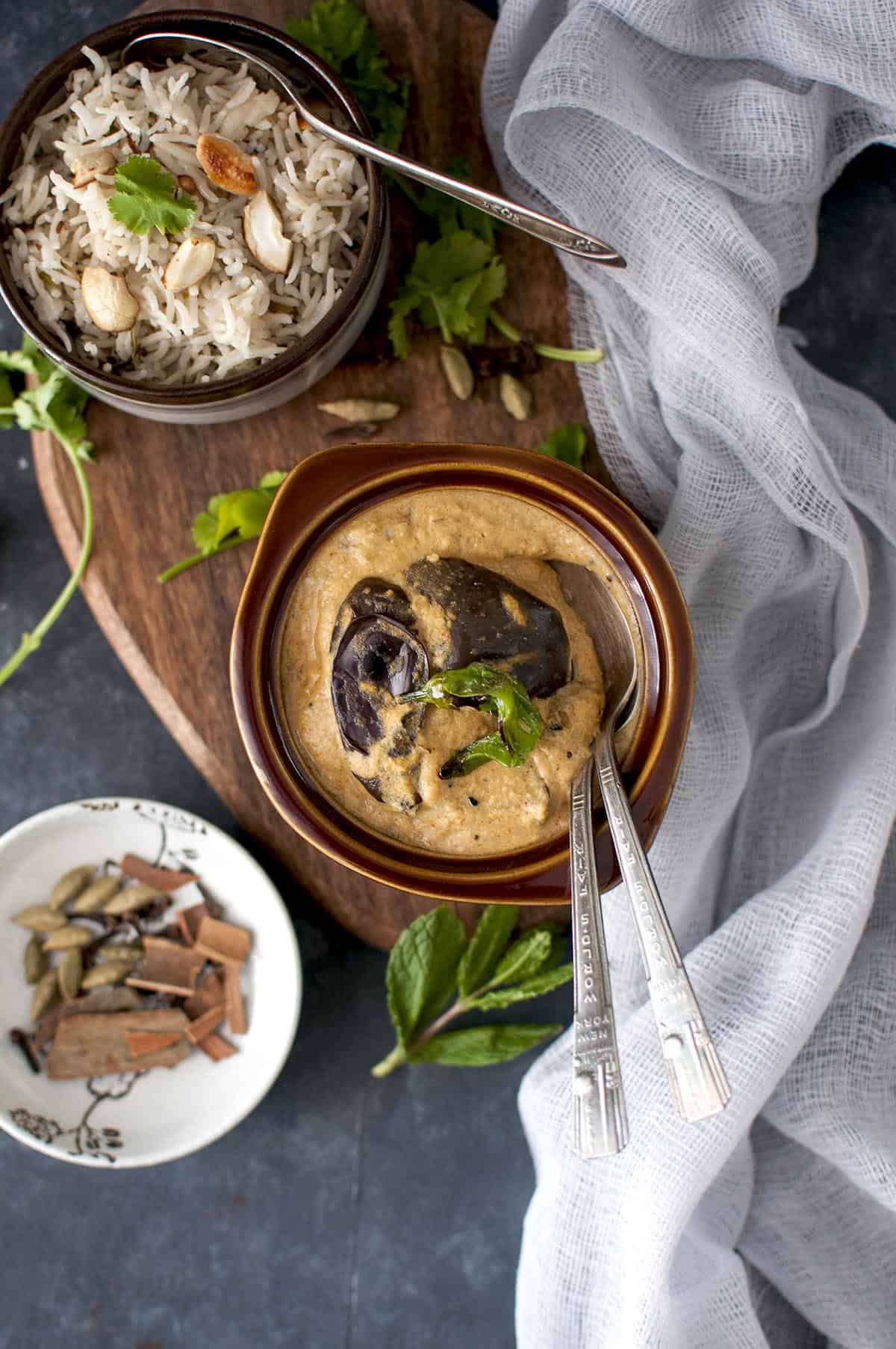 Top view of brown bowl with brinjal salan