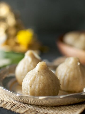 Silver plate with 3 jowar modak