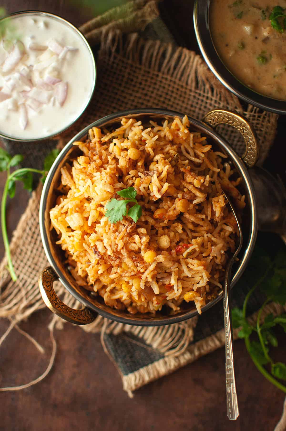 Brass bowl with Qabooli biryani.