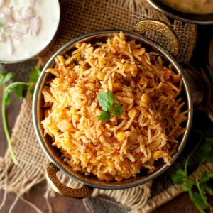 Brass bowl with Qabooli biryani.