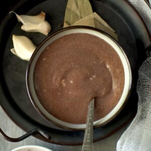 Black tray with a grey bowl of ragi porridge