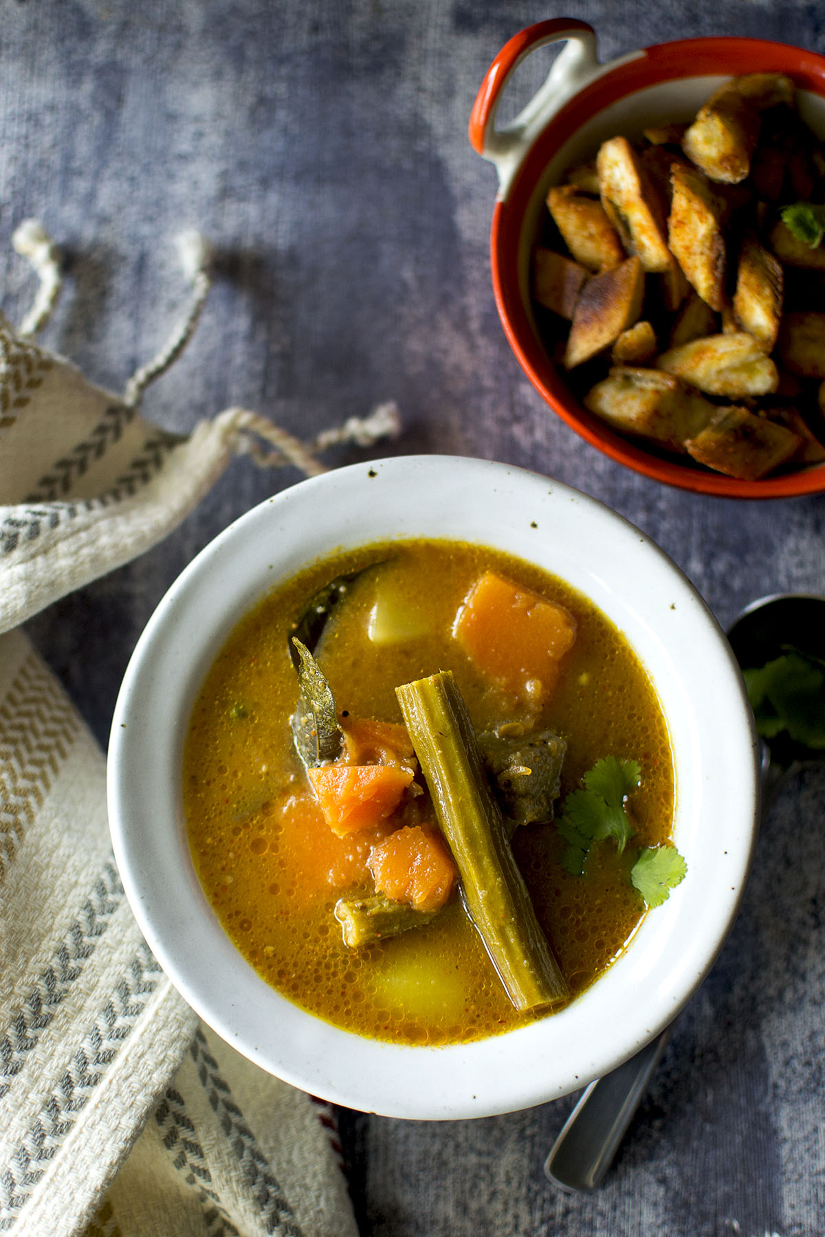 Grey bowl with sweet and sour thiyya pulusu