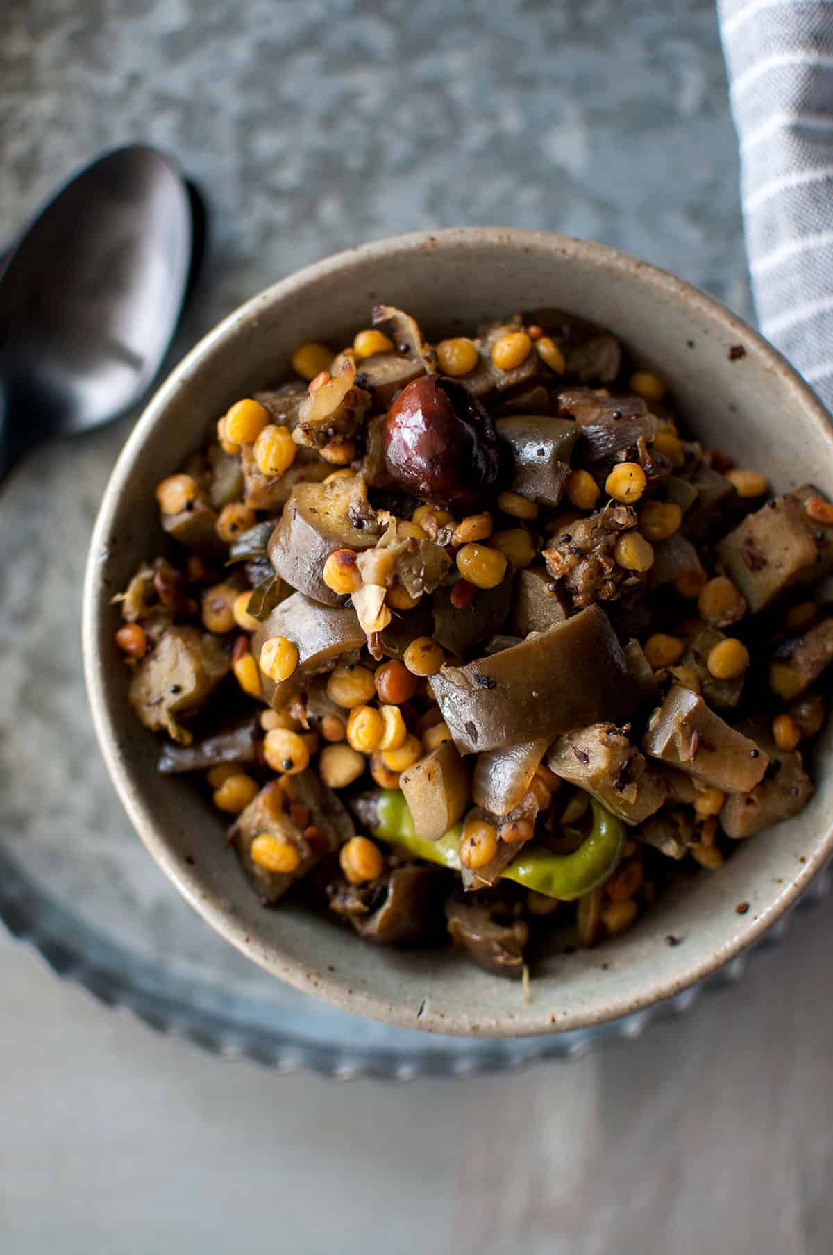 Grey bowl with vankaya senagapappu iguru.