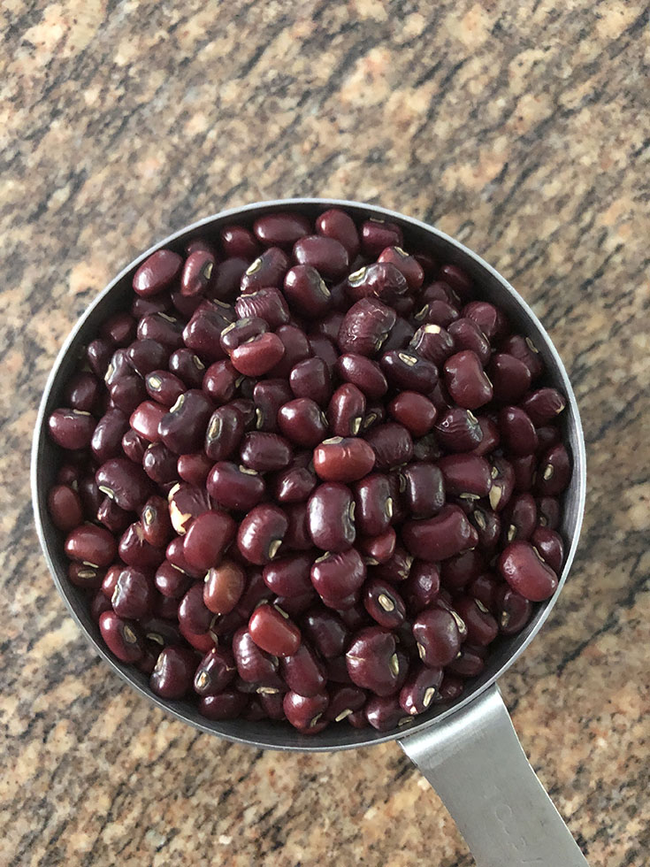 Steel cup with dry adzuki beans