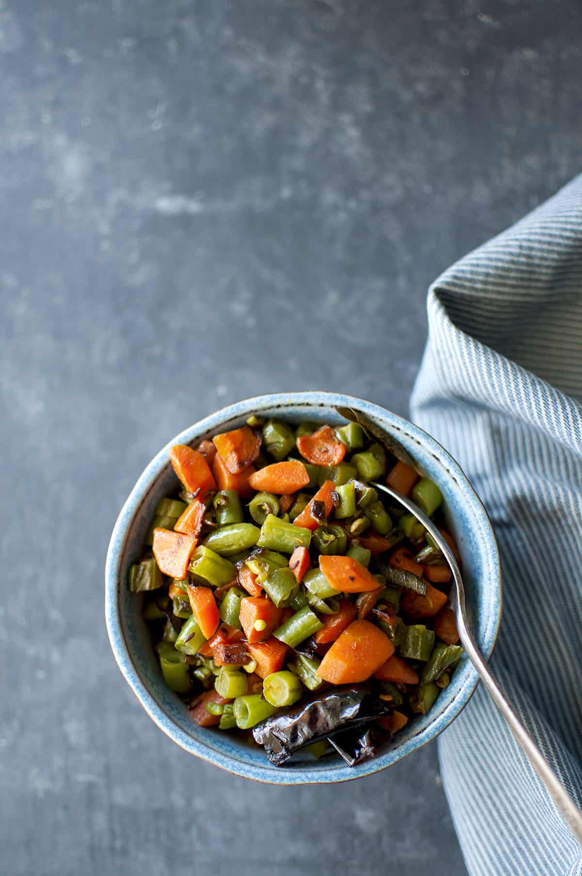 Blue bowl with carrot and green bean stir fry