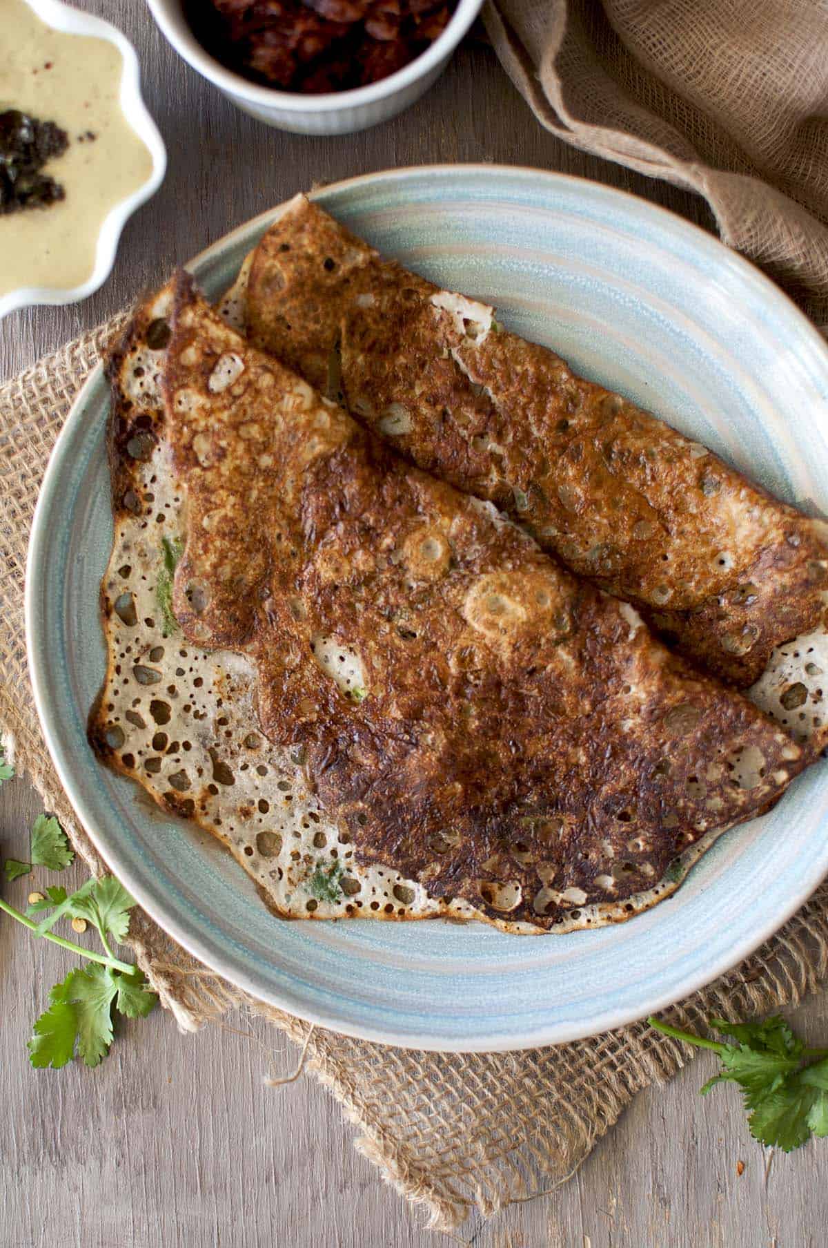 Blue plate with 2 crispy rava dosa