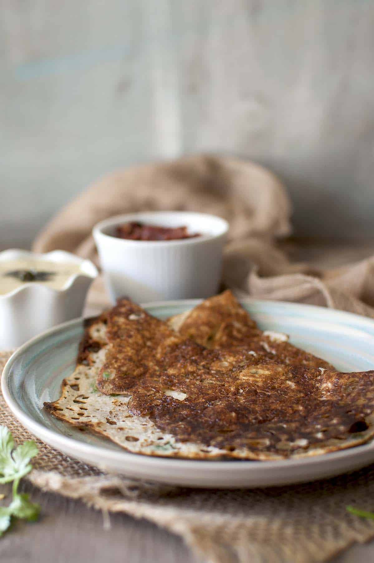 grey plate with rava dosa and onion chutney