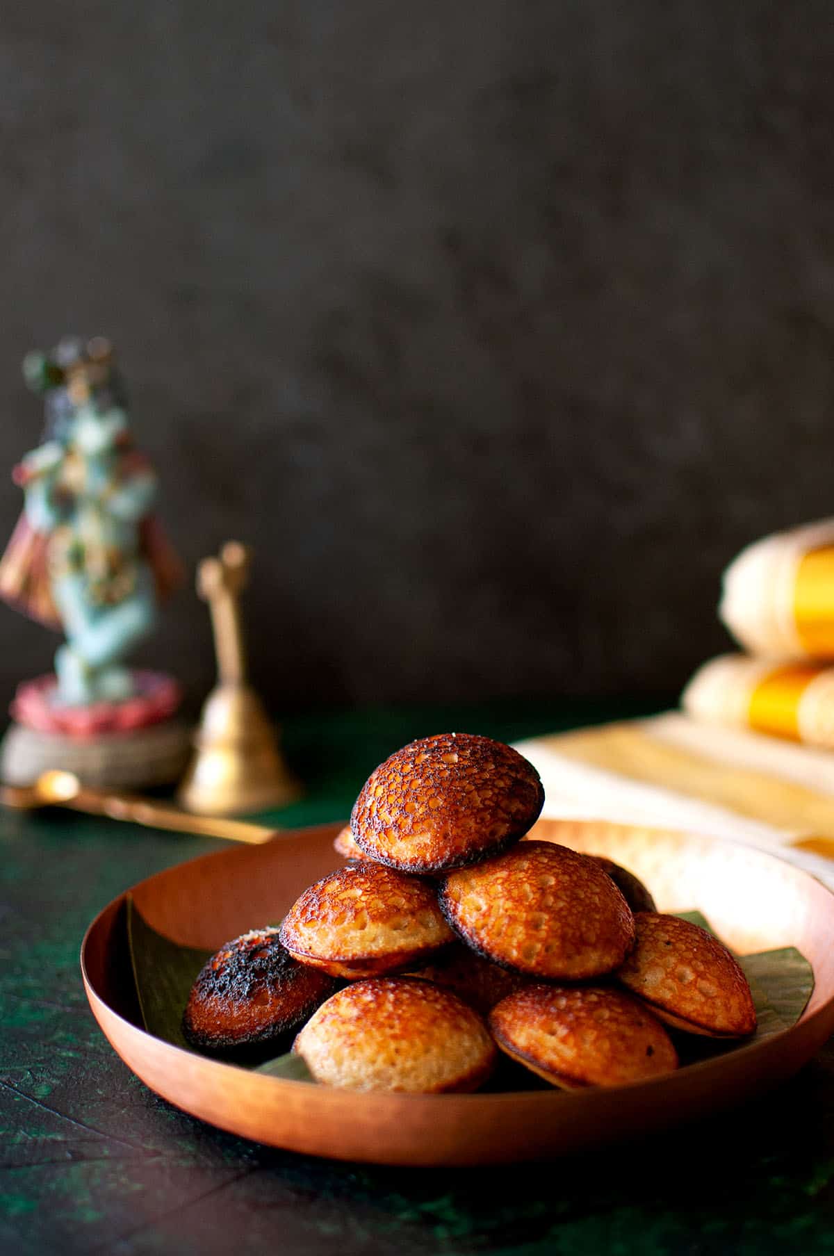 Plate with a stack of unniyappam.
