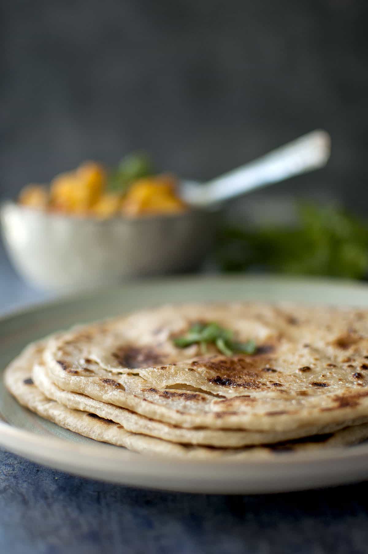 Blue plate with layered and flaky parotta