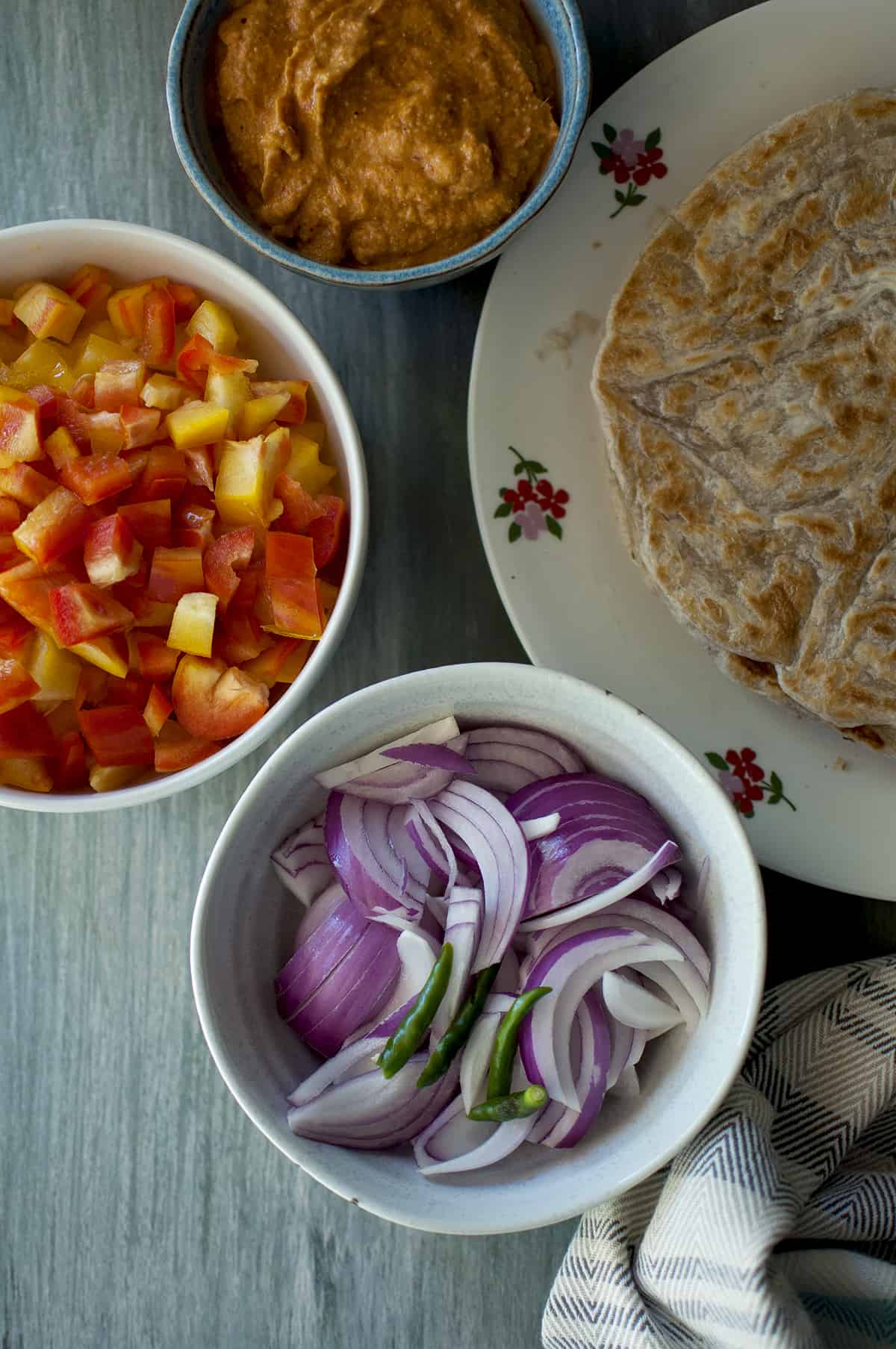 Ingredients needed - salna, parotta, sliced onions, green chilies, peppers.