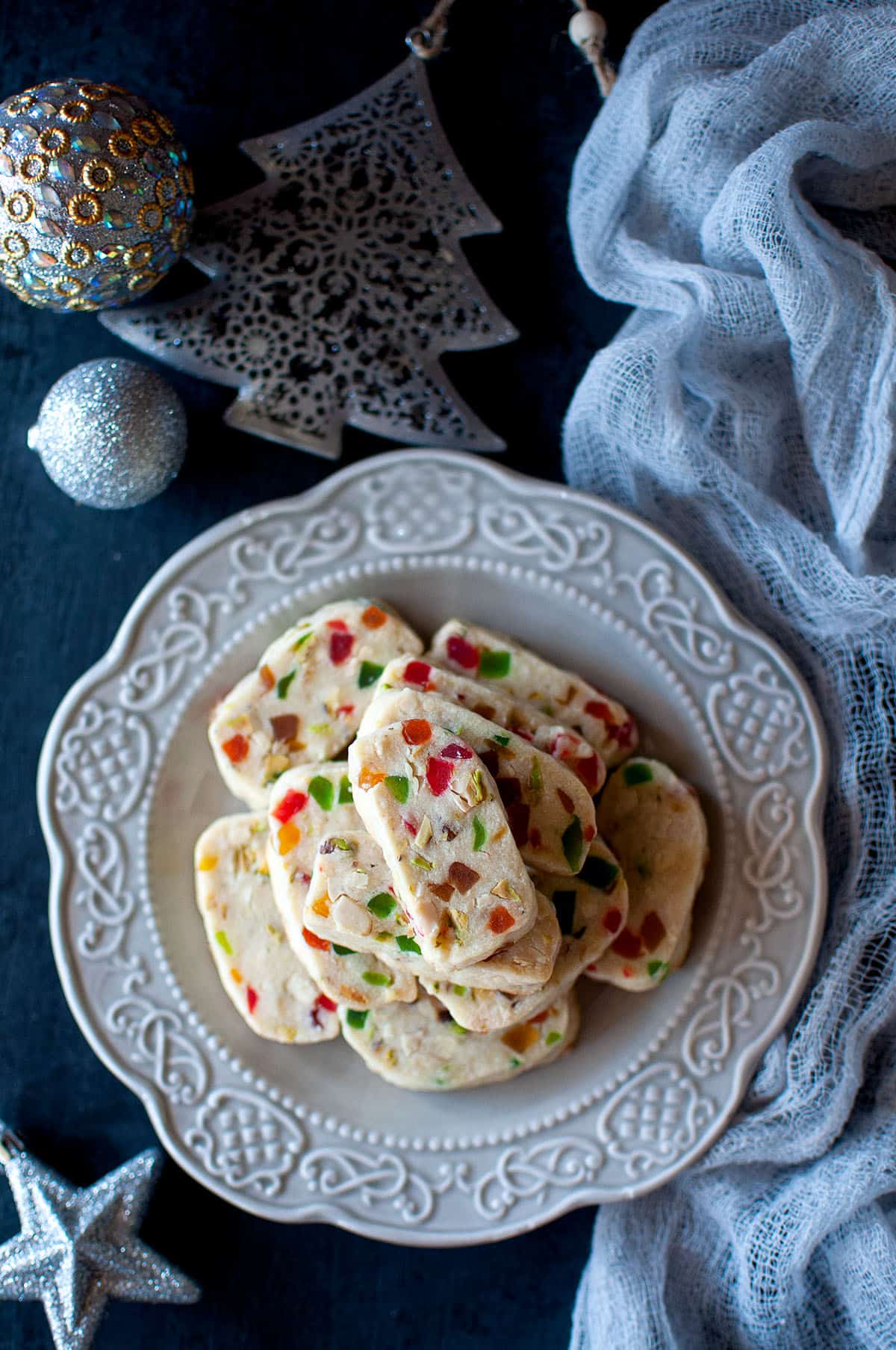 Grey plate with a stack of tutti frutti cookies.