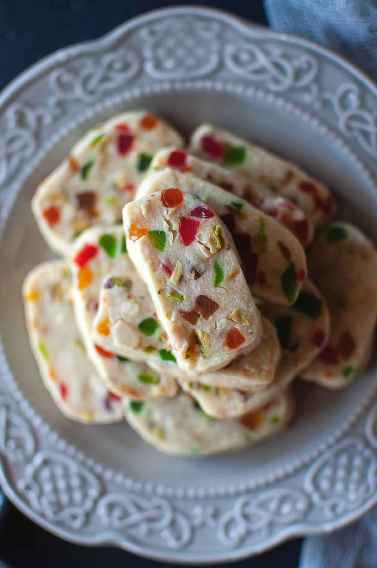 Top view of a grey plate with tutti frutti cookies.