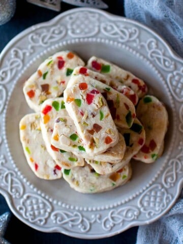 Top view of a grey plate with tutti frutti cookies.