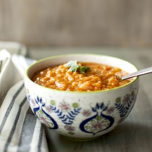 White bowl with Ethiopian red lentil stew.