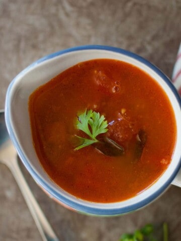 White bowl with tomato broth.