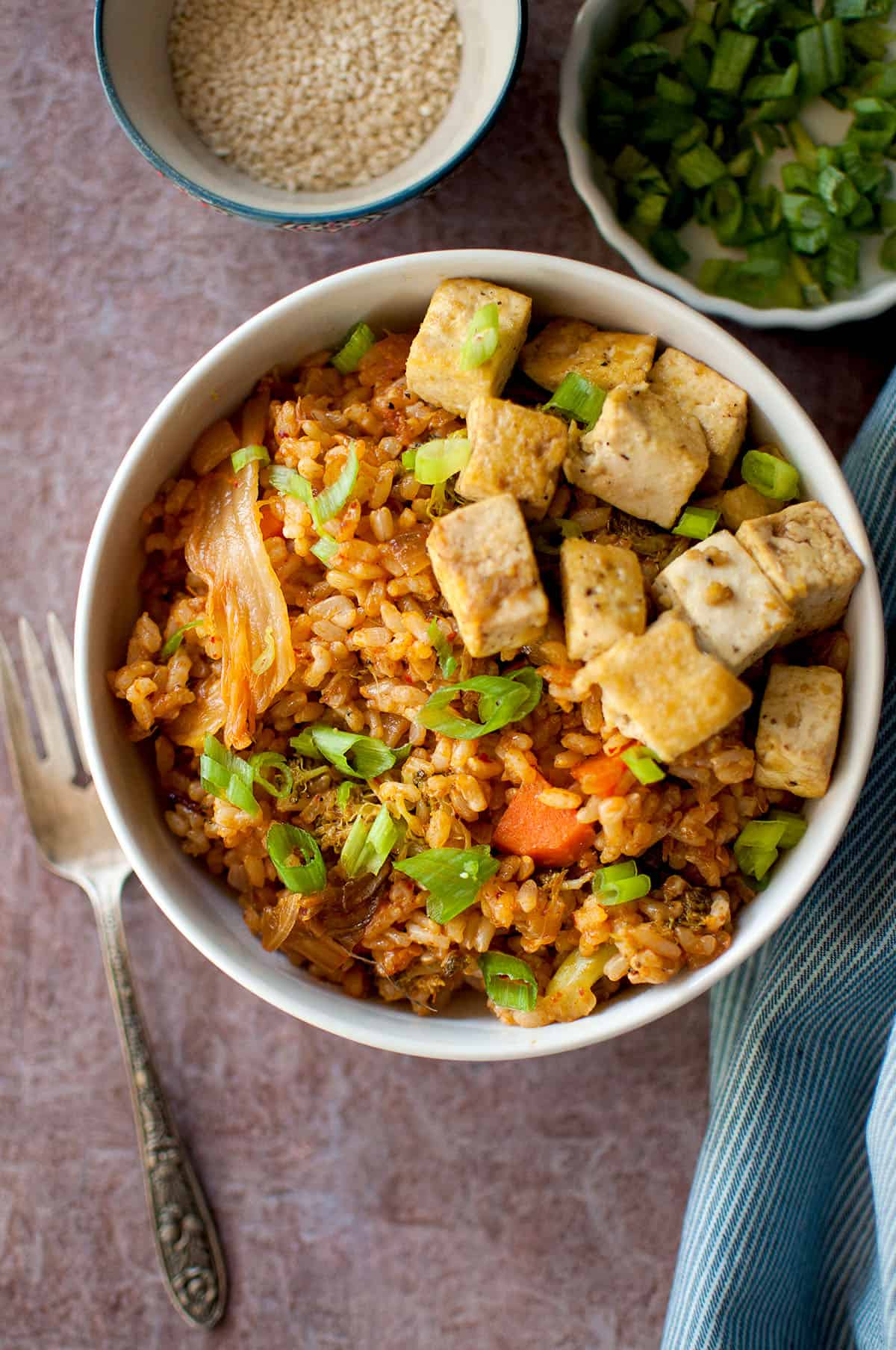 Bowl with vegetarian fried rice topped with tofu.