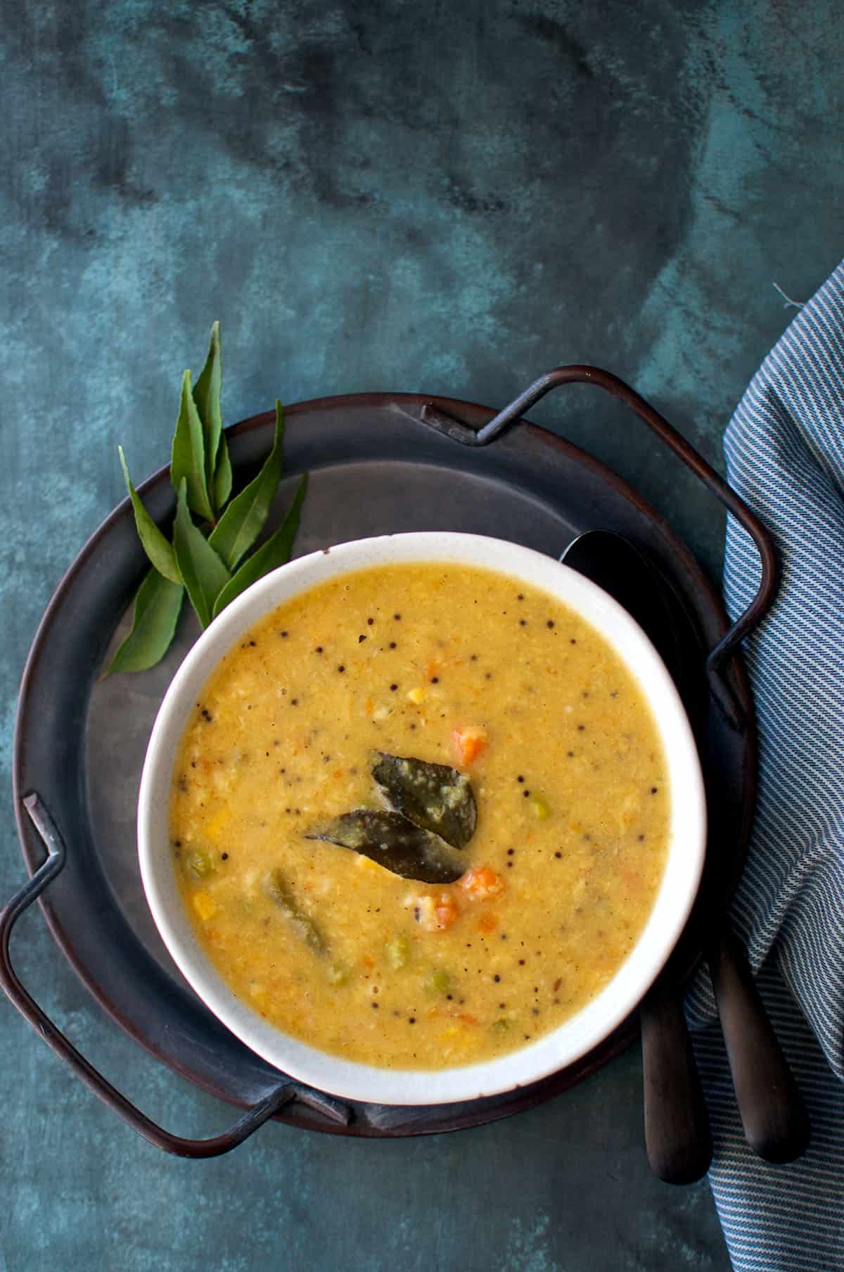 Top view of a tray and a bowl of veggie kootu.