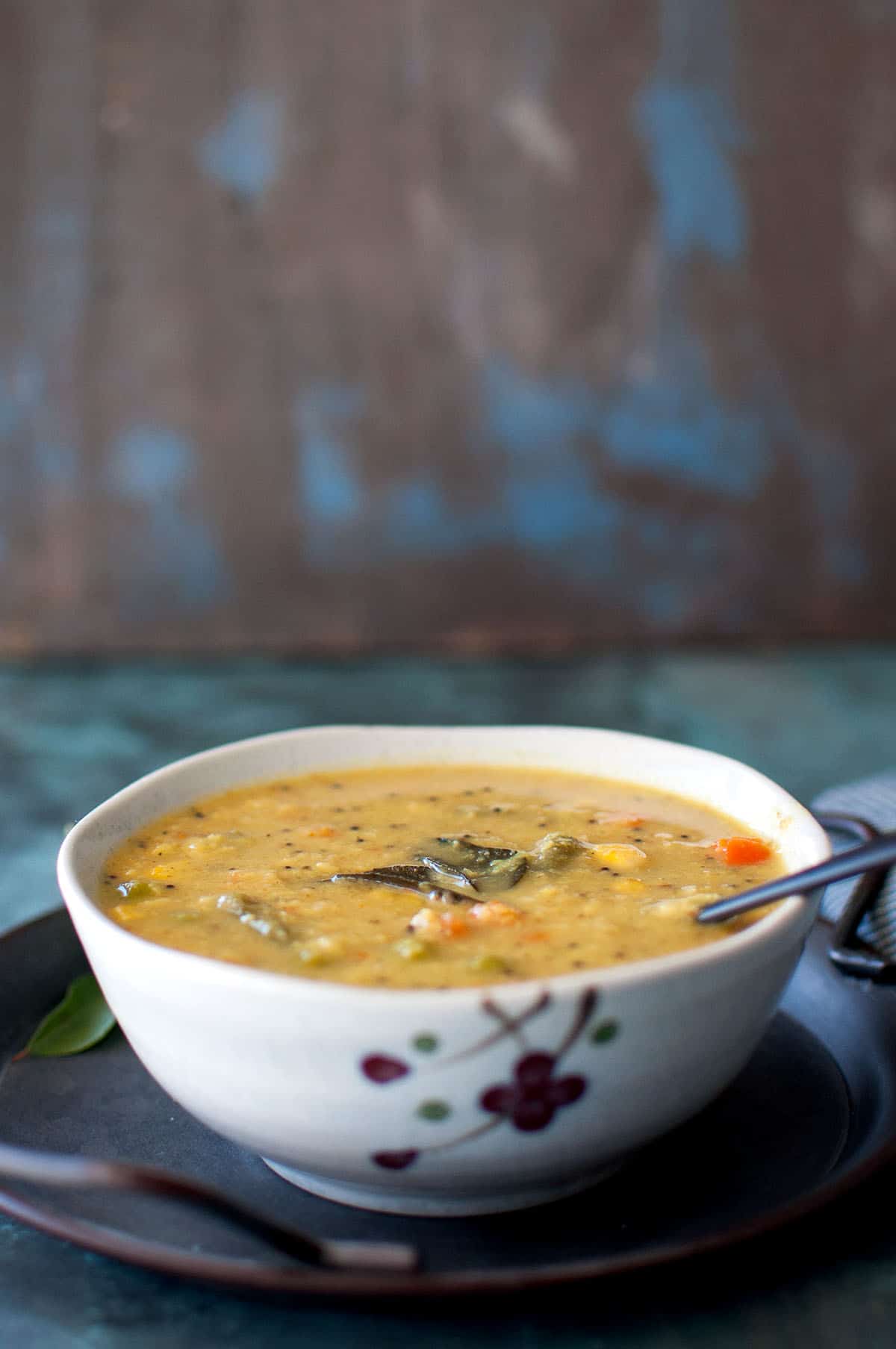 White bowl with mix vegetable kootu.