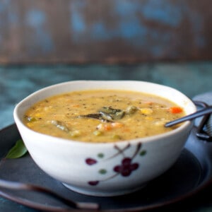 White bowl with vegetable kootu curry.