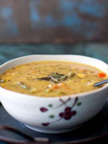 White bowl with vegetable kootu curry.