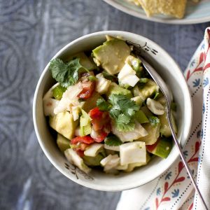 Grey bowl with avocado, tomato, coconut meat salsa