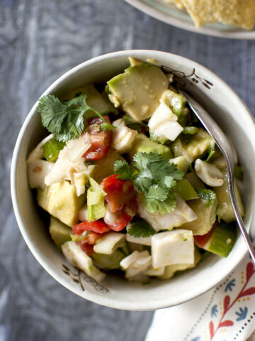 Grey bowl with avocado, tomato, coconut meat salsa