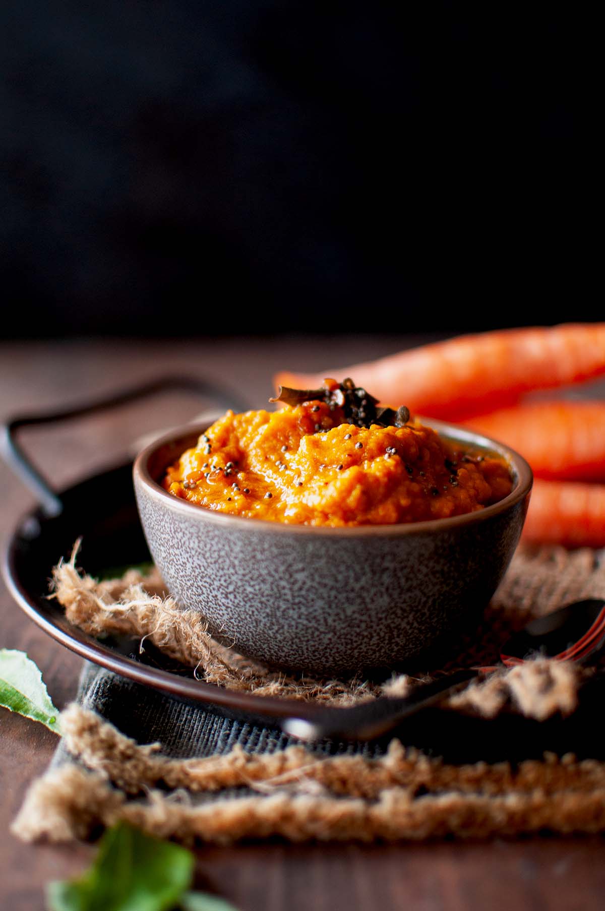 Grey bowl with grated carrot chutney