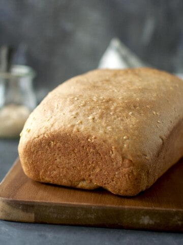 Chopping board with a loaf of hummus bread