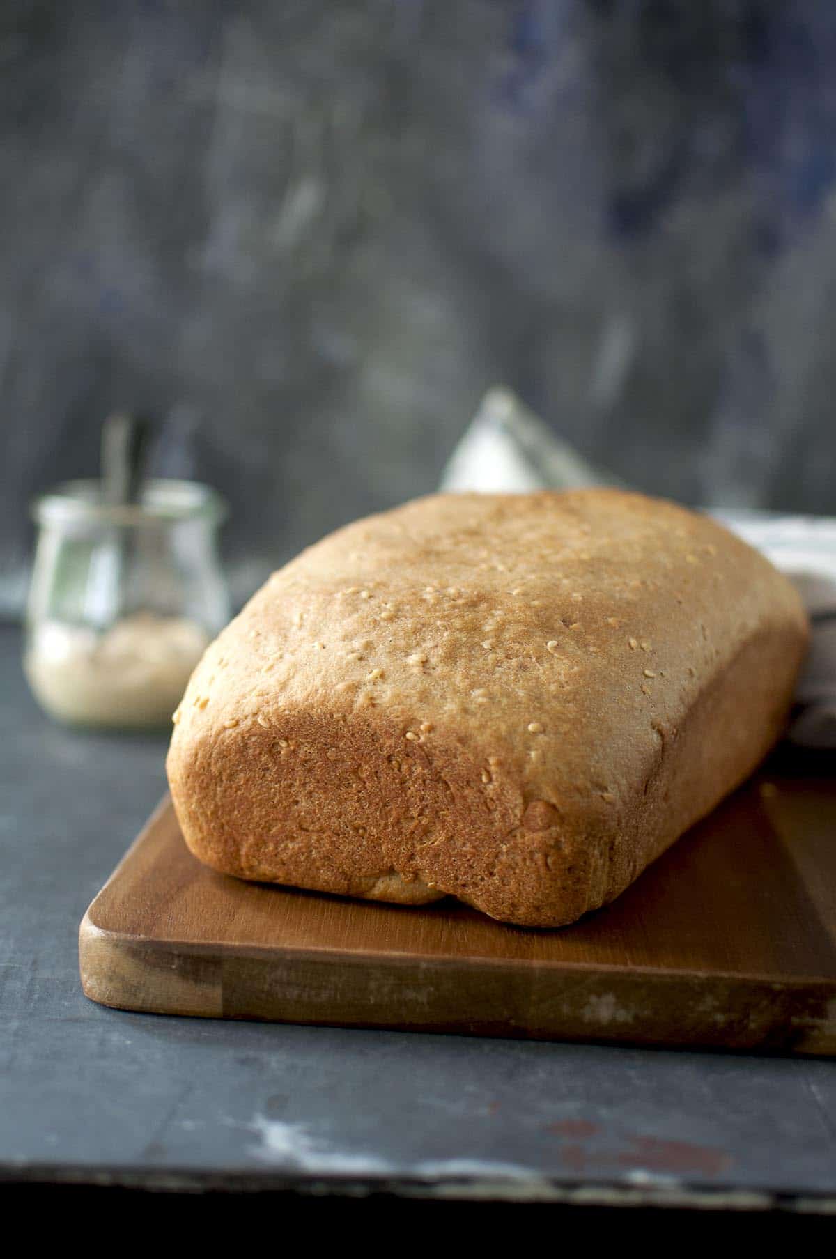 Chopping board with a loaf of hummus bread