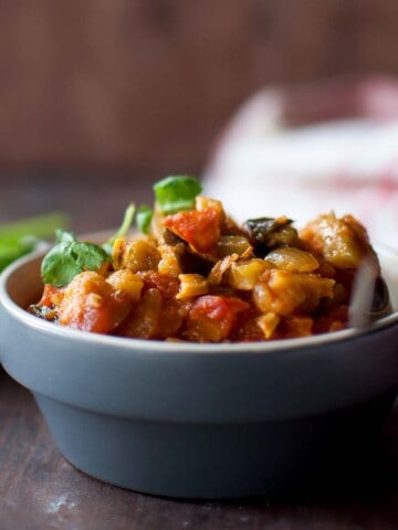 Grey bowl with kakarakaya tomato curry