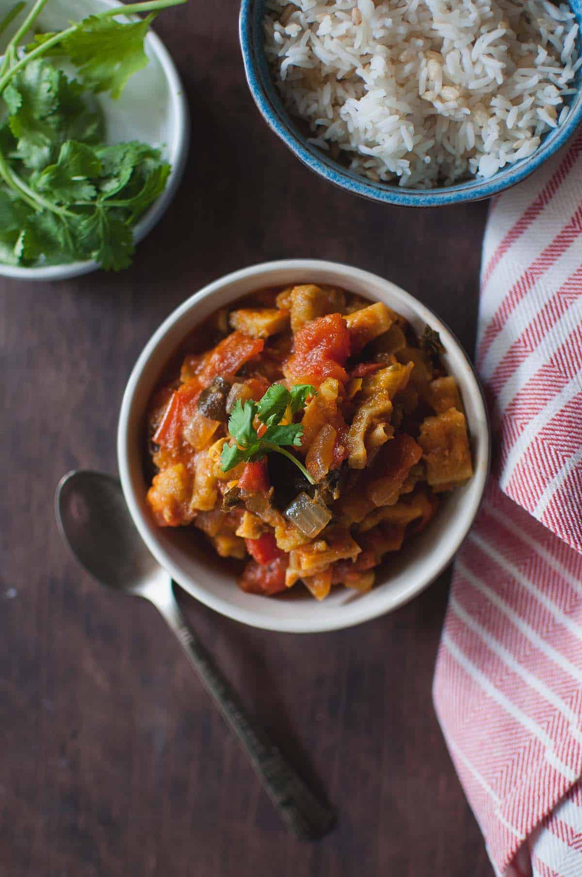 White bowl with bitter gourd tomato curry