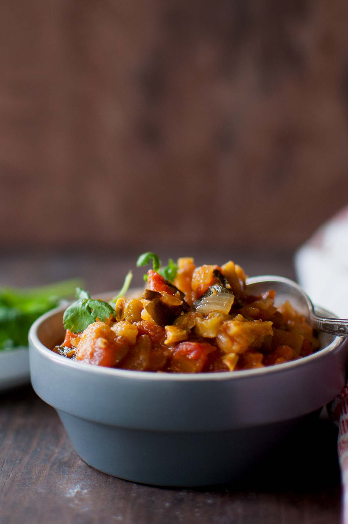 Grey bowl with kakarakaya tomato curry