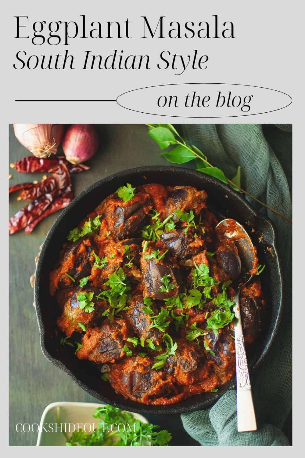 Cast iron pan with spicy brinjal curry topped with cilantro.