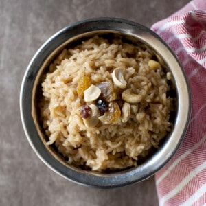 Steel bowl with rice pudding with jaggery