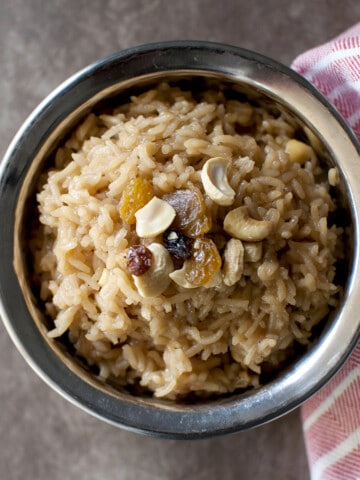 Steel bowl with rice pudding with jaggery