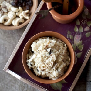 Burgundy tray with a bowl of kesaribath