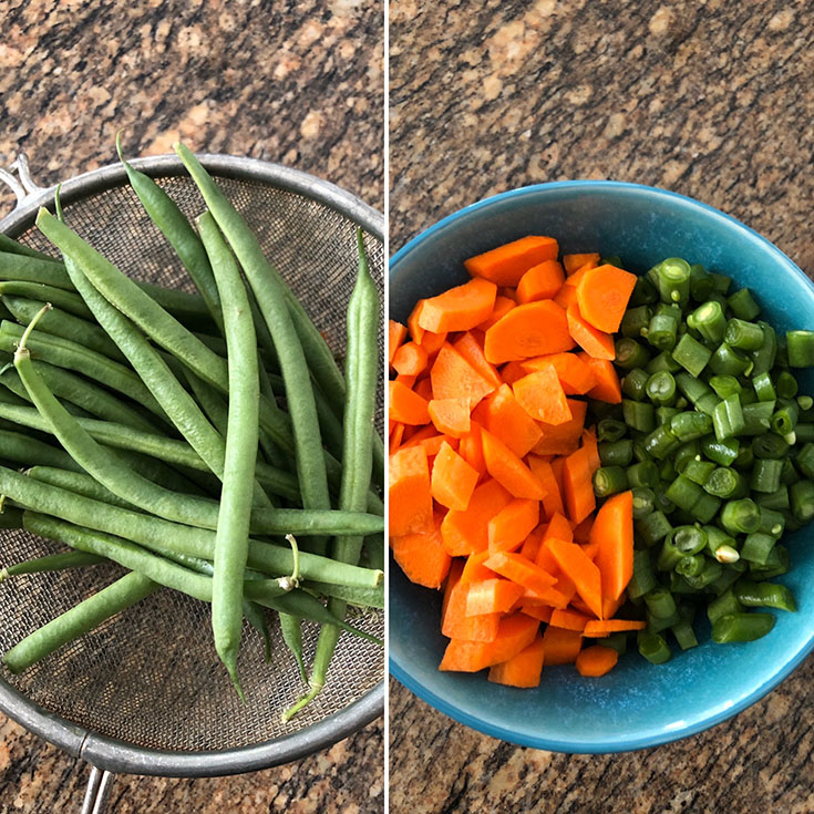 Green Beans in a sieve and chopped green beans and carrot in blue bowl