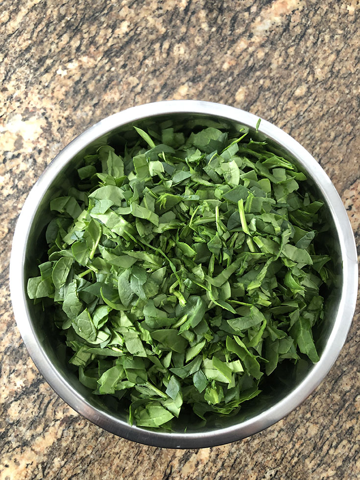 Steel bowl with chopped greens