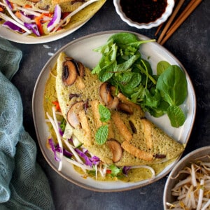 Grey plate with mushroom filling mung bean pancakes.