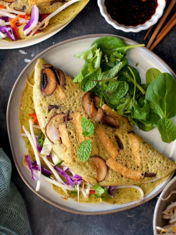 Grey plate with mushroom filling mung bean pancakes.